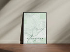 Flagstaff map print in the Forest theme in a black frame on a wooden surface against a pale wall