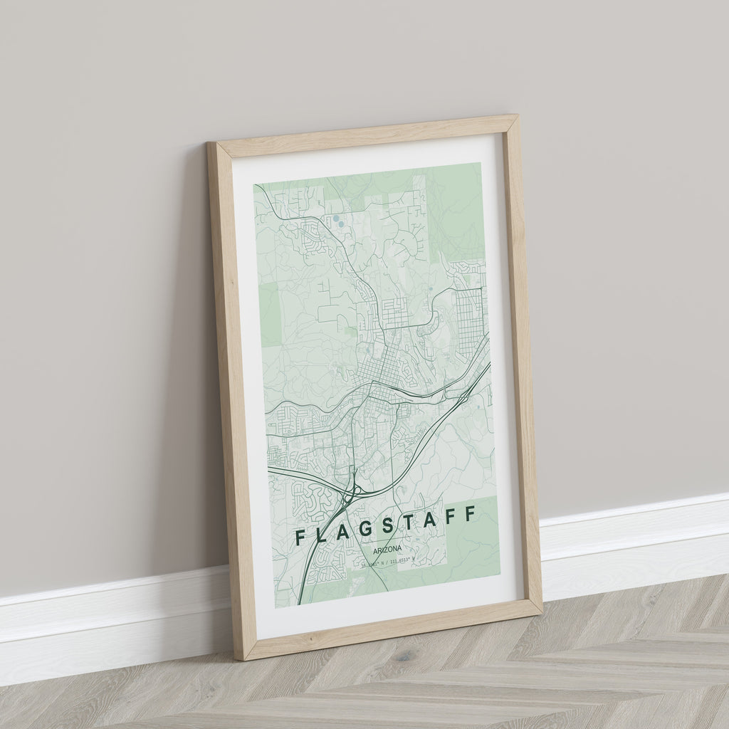 Flagstaff map print in the Forest theme in a light wooden frame leaning against a pale wall