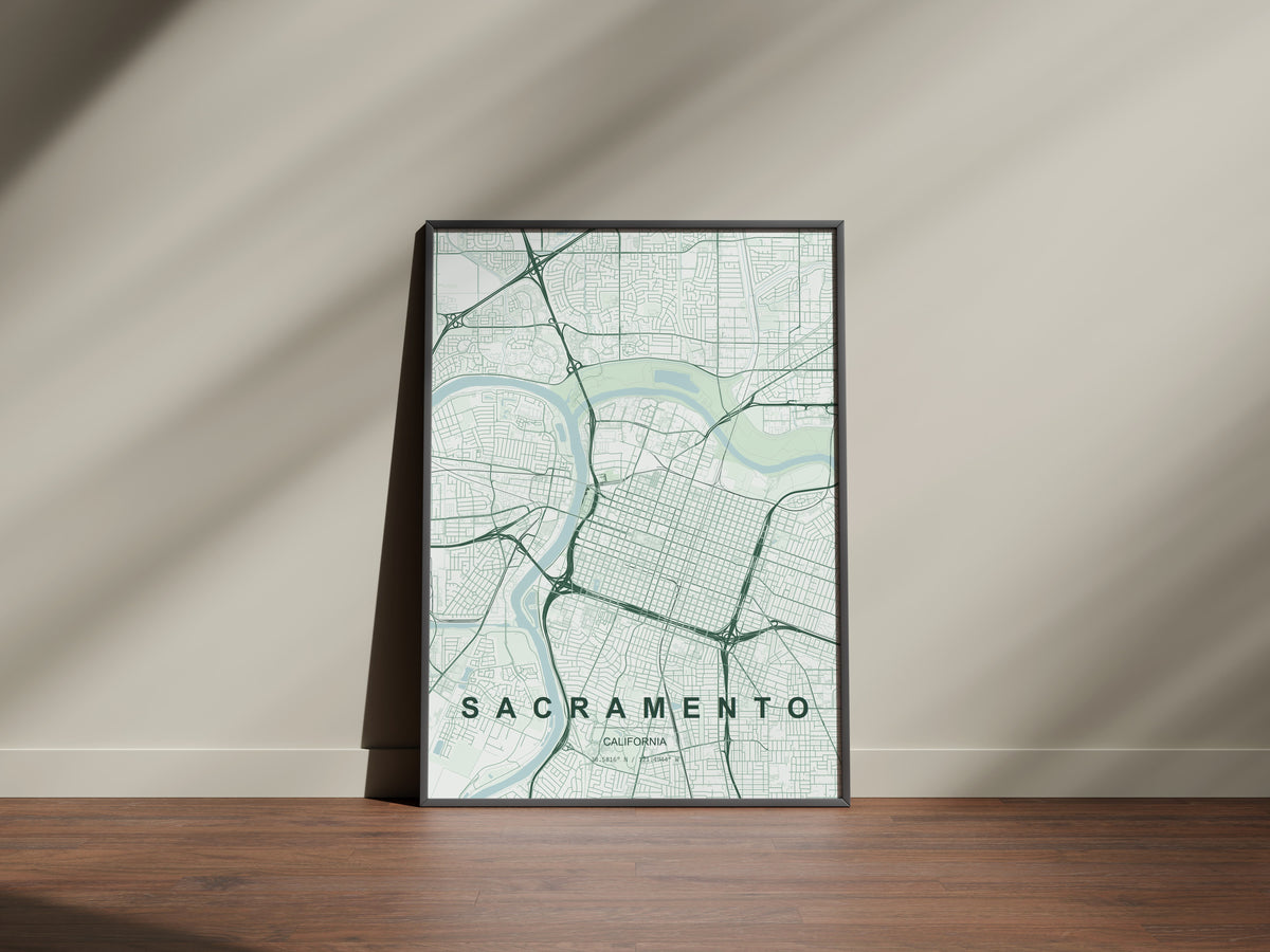 Sacramento map print in the Forest theme in a black frame on a wooden surface against a pale wall