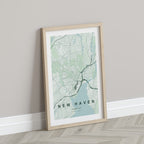 New Haven map print in the Forest theme in a light wooden frame leaning against a pale wall