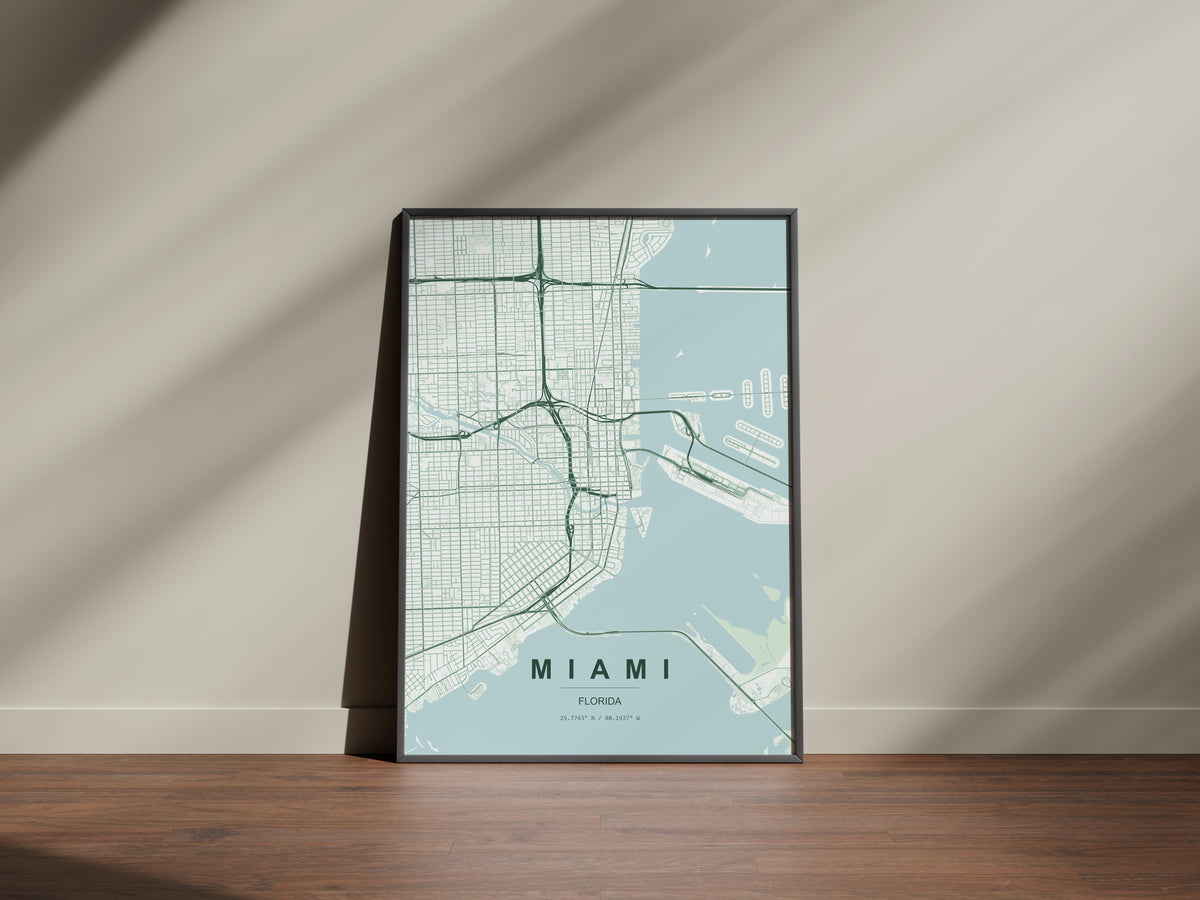 Miami map print in the Forest theme in a black frame on a wooden surface against a pale wall
