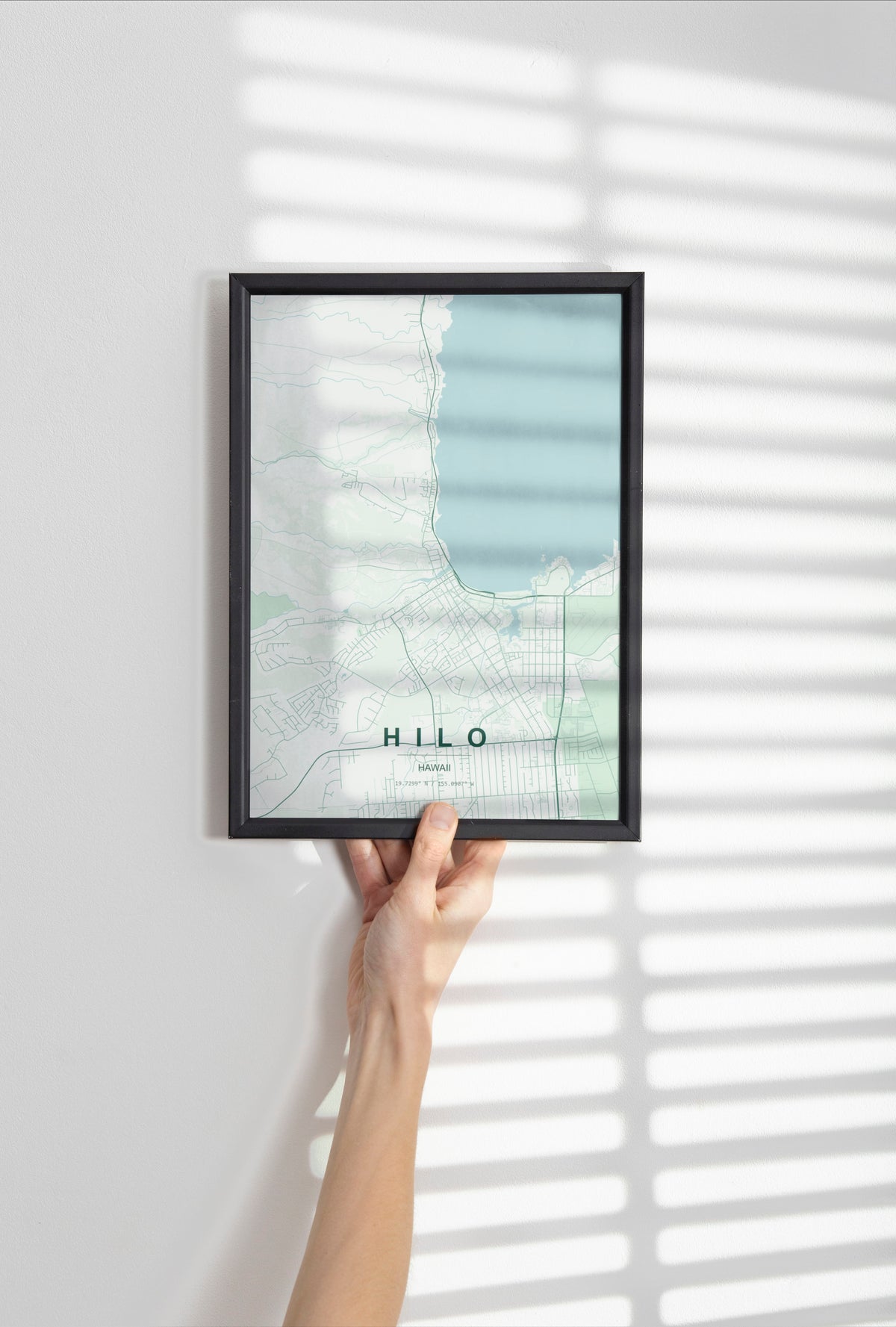 Hilo, Hawaii, United States map print in the Forest theme in a black frame held against a pale wall