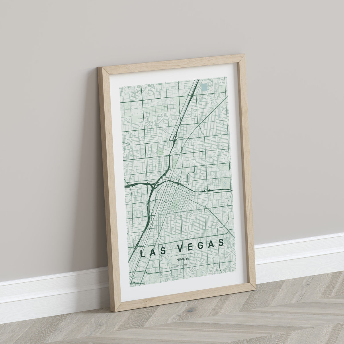 Las Vegas map print in the Forest theme in a light wooden frame leaning against a pale wall