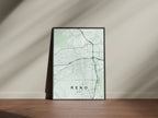 Reno map print in the Forest theme in a black frame on a wooden surface against a pale wall