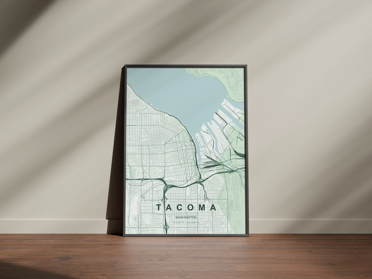 Tacoma map print in the Forest theme in a black frame on a wooden surface against a pale wall
