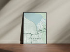 Tacoma map print in the Forest theme in a black frame on a wooden surface against a pale wall