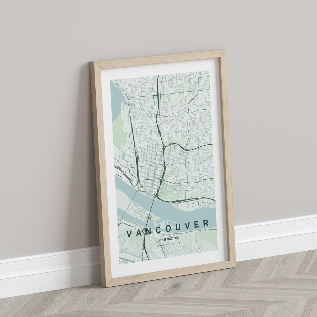 Vancouver map print in the Forest theme in a light wooden frame leaning against a pale wall